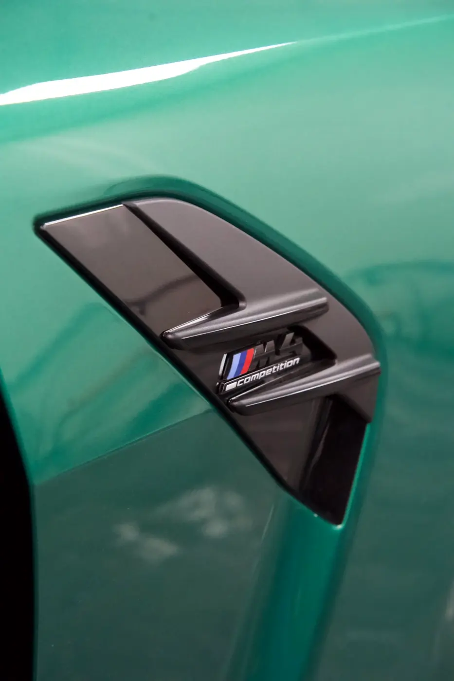 Détail de la carrosserie verte d'une BMW M4 CS